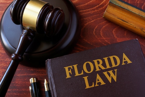 A gavel and a book titled Florida law. Image signals that Florida specific law applies.