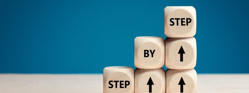 The,Word,Step,By,Step,On,Wooden,Cubes.,Achievement,Or